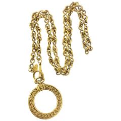 Vintage CHANEL long chain necklace with round glass loupe pendant top and CC.