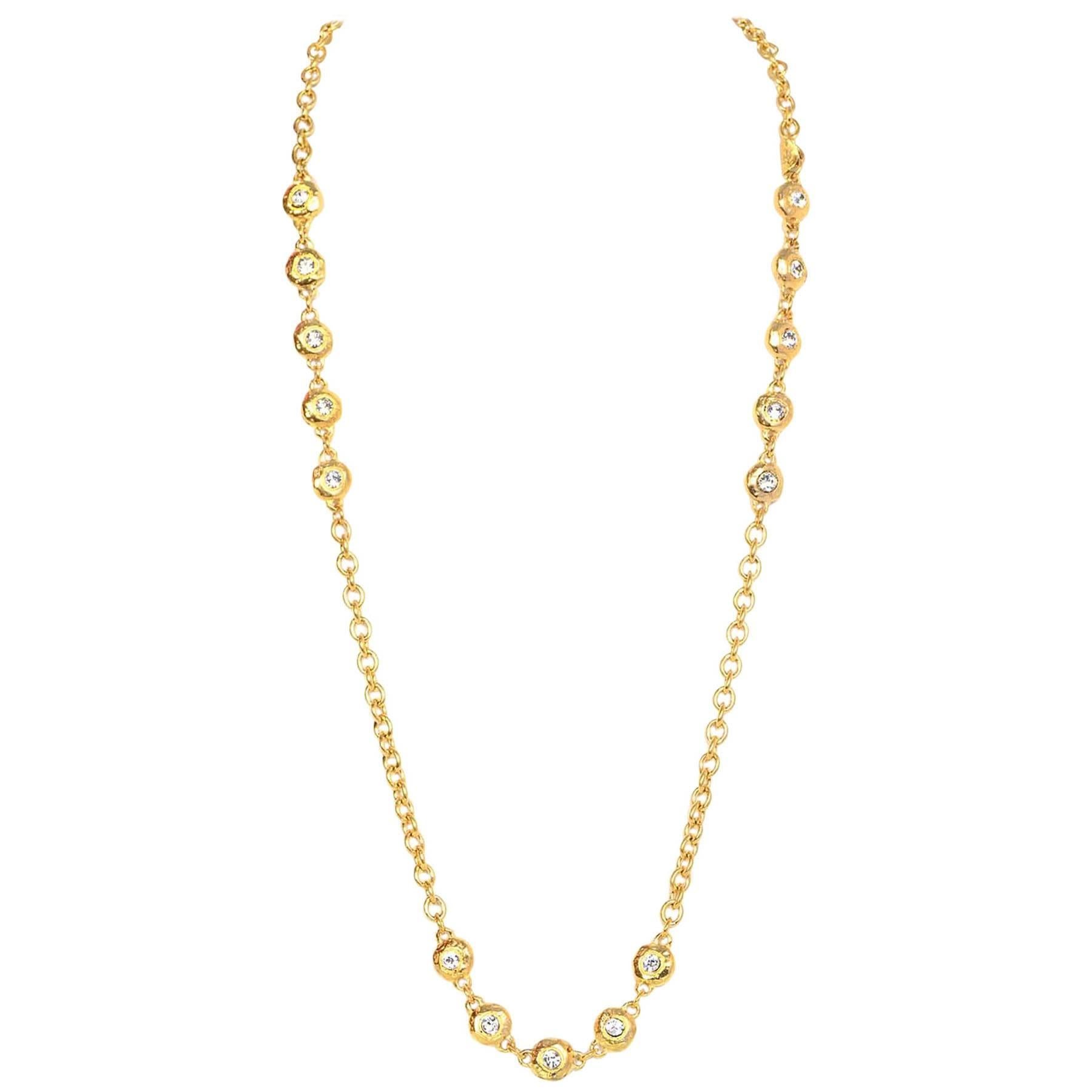 100% Authentic Chanel Chanel Vintage 36" Chain-link Crystal Necklace. Features bright goldtone metal with five clear crystals in between chain throughout. Necklace can be worn long or doubled.

 **Please necklace has been re-dipped to appear a