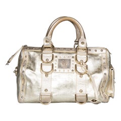 Versace, borsa in pelle dorata con chiusura a scatto