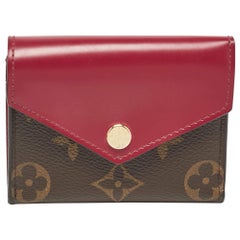 Cartera Zoe de lona y piel con monograma fucsia de Louis Vuitton