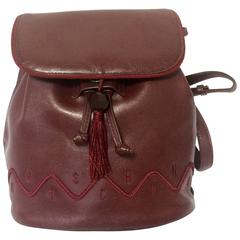 Retro MOSCHINO dark wine leather backpack with tassel and logo embroidery.