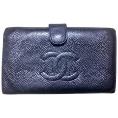 Vintage CHANEL black caviar leather wallet with large CC stitch mark logo.
