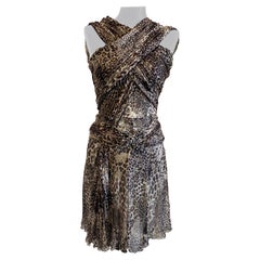 Blumarine silk dress with spotted print and beaded bow at the waist.