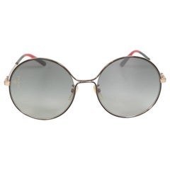 Graue, getönte Gucci-Sonnenbrille mit rundem Rahmen