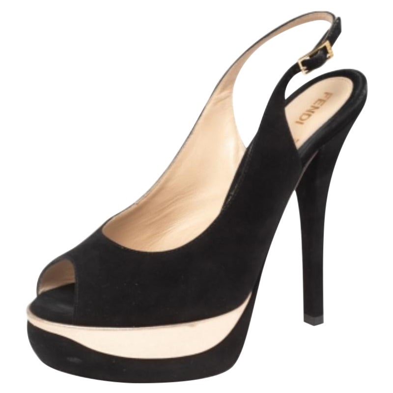 Fendi's timeless aesthetic and stellar craftsmanship in shoemaking is evident in these versatile sandals. Crafted from black suede, the peep-toe silhouette is adorned with sleek cuts and then raised on high heels supported by platforms.