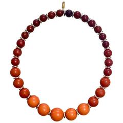 Vintage Yves Saint Laurent orange brown gradation color ball statement necklace.