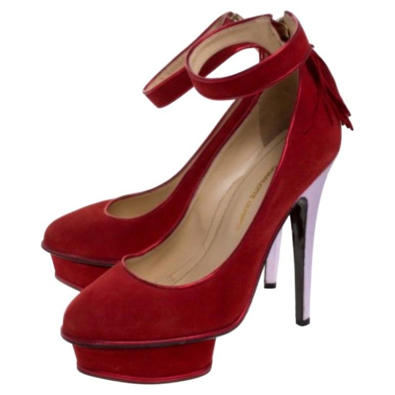 Walk and feel like a diva with these platform pumps from Charlotte Olympia. They've been wonderfully crafted from red suede and designed with closed toes, platforms, buckle straps around the ankles and 14 cm heels to give you the right confidence.