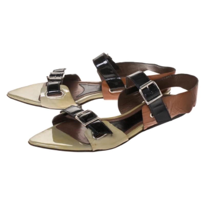 These sandals from Marni will lend a stylish and playful edge to your feet. They have been crafted in Italy and made from patent leather. They come in three lovely hues. These pointed flats come with open toes, buckled straps, silver-tone hardware