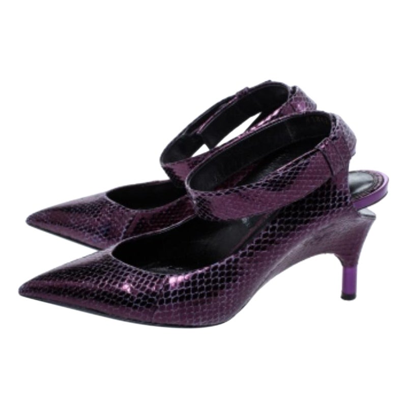 Effortlessly stylish and glamorous pumps come from the iconic house of Tom Ford. Crafted in Italy, they are made from exotic snakeskin, they come in a lovely shade of plum. They are styled with pointed toes, cut-out detailing, buckled ankle straps,