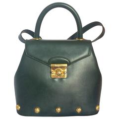 Vintage Salvatore Ferragamo deep green leather bag with gold tone motifs. 