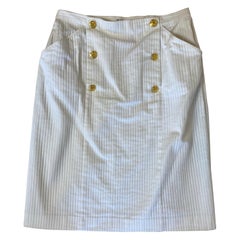 White Céline skirt with gold buttons.