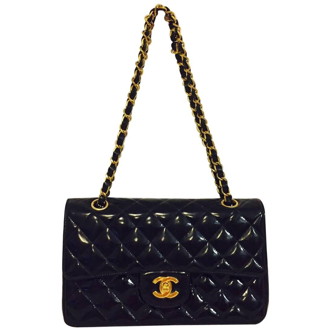 Chanel Classic Patent Leather Flap Bag is highly desired worldwide and a must for any serious connoisseur's collection of all things Coco! Features black diamond quilted patent leather body, gold tone hardware and patent leather interwoven cross