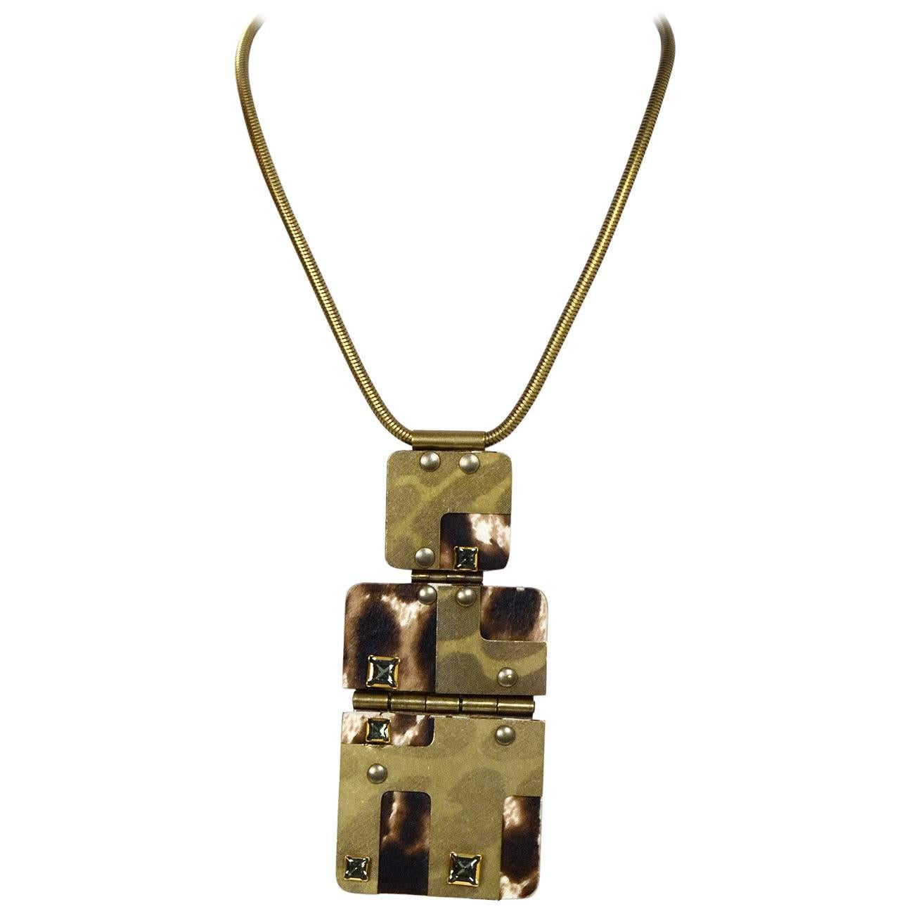 Lanvin Ponyhair & Crystal Pendant Necklace 
Features metal, ponyhair, and crystal detailed large pendant and lever to shorten or lengthen 

Made In: France
Color: Antiqued goldtone, brown and beige
Materials: Metal, ponyhair and