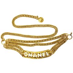 MINT. Vintage CHANEL golden three strand chain belt with quilted and logo motif.