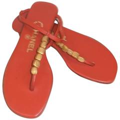 Red leather Chanel thong sandals with gold-tone logo bead embellishments 35