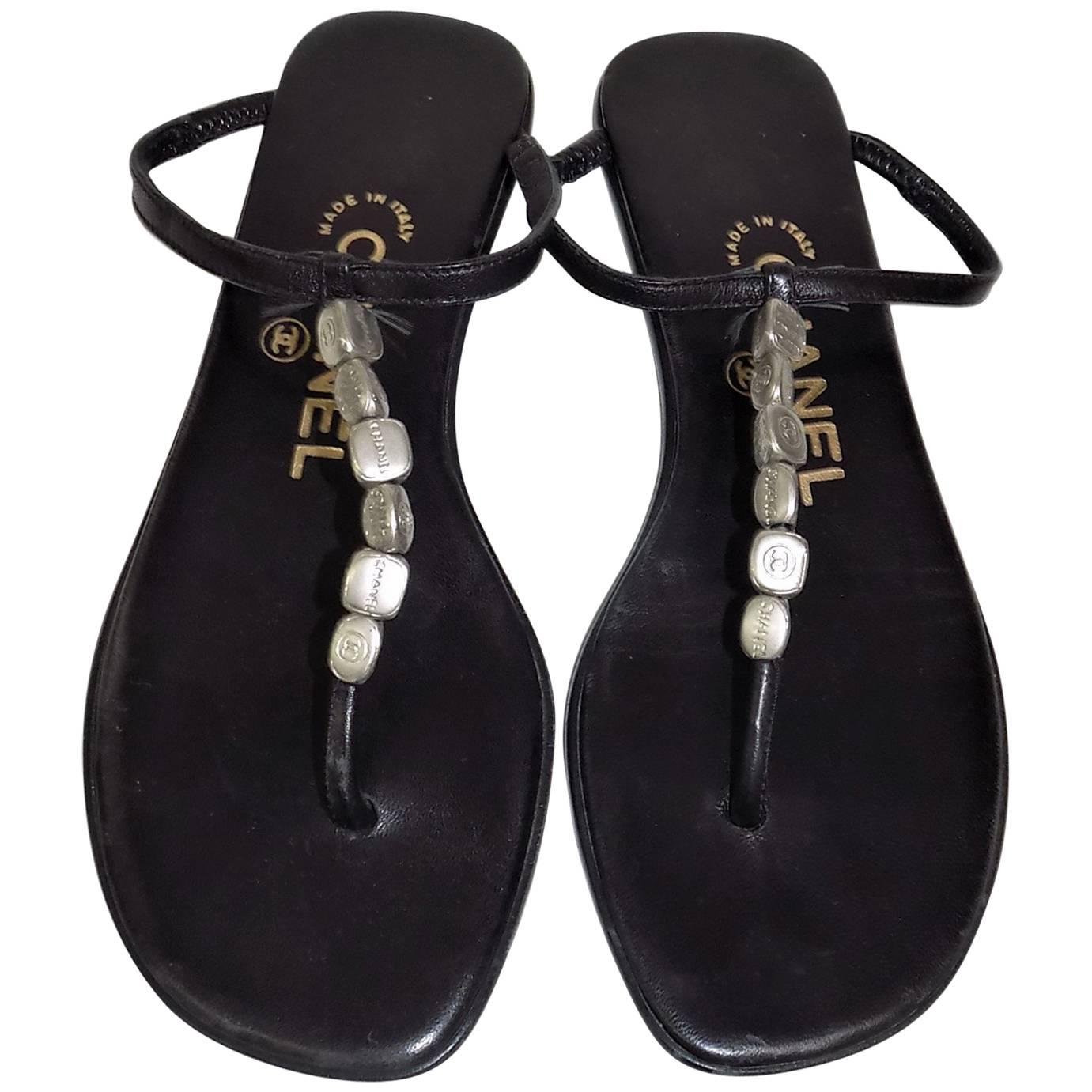 Black leather Chanel thong sandals with silver-tone logo charmes sz 35