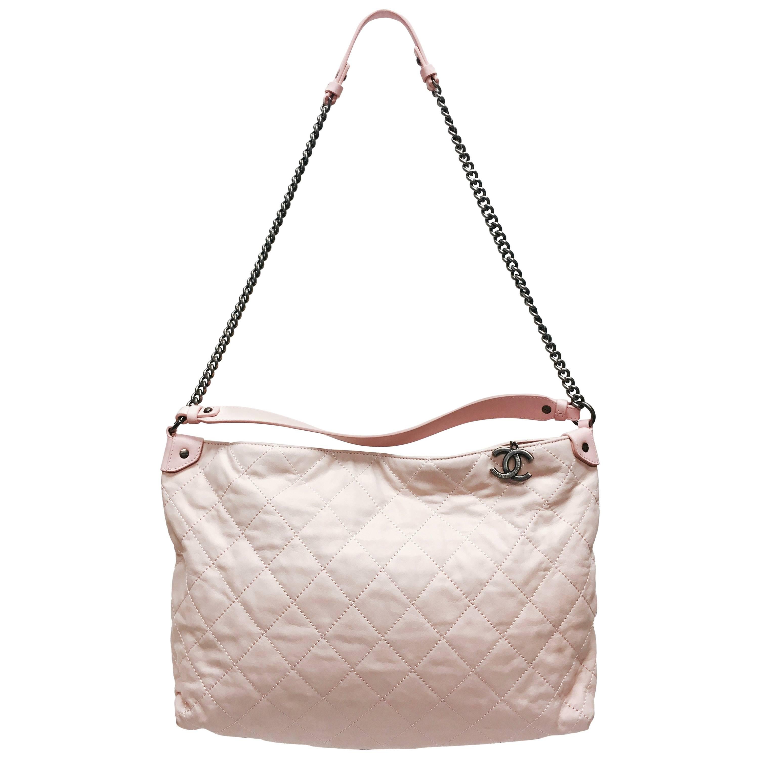 CHANEL Light Pink Quilted Calfskin Leather Coco hobo bag from the 13C collection. Relaxed and versatile design is perfect for casual luxury. This bag features a long ruthenium chain strap for hands-free wear with a leather shoulder strap and a