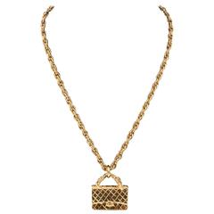 Chanel gilt charm necklace with a quilted Chanel bag pendant dated 1994 6