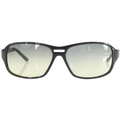 Gafas de sol Prada con montura negra y lentes tintadas amarillas