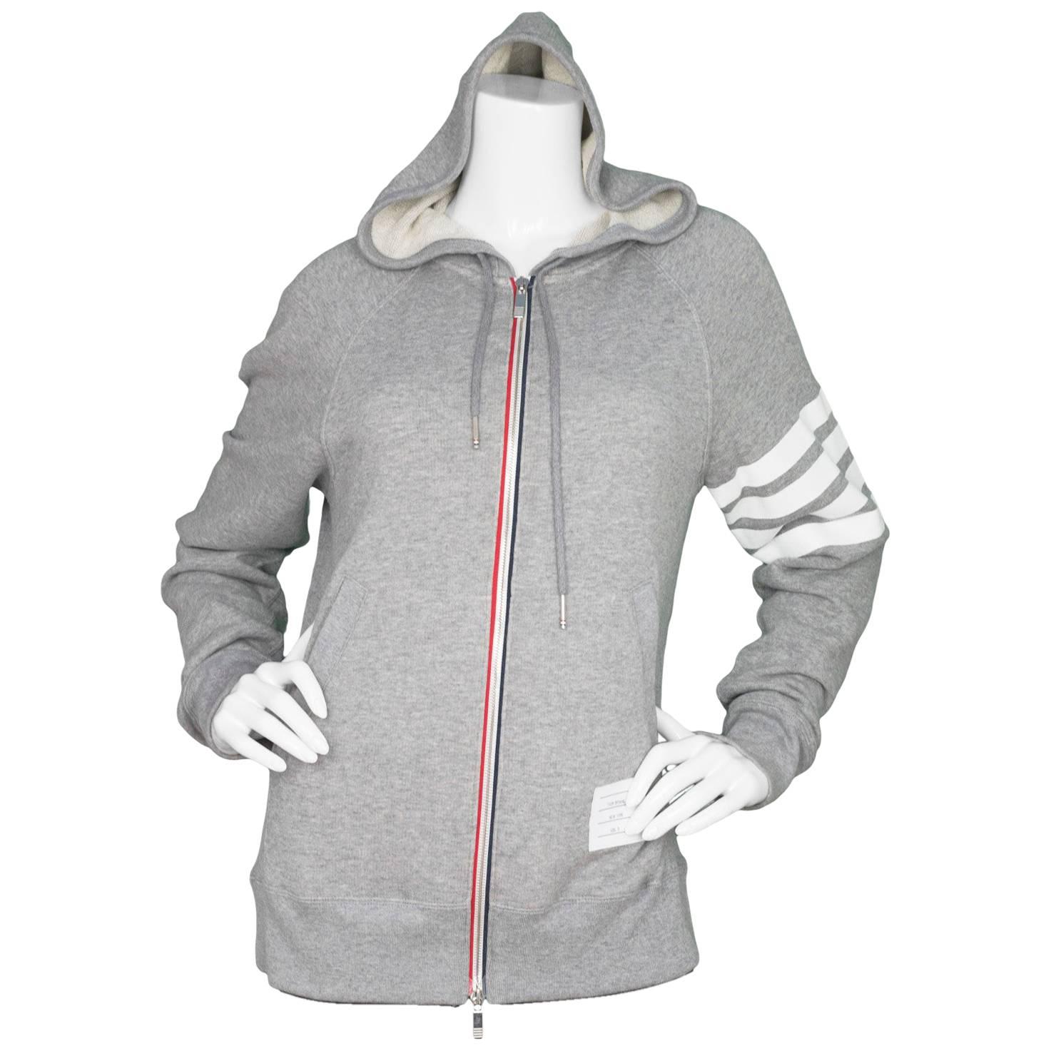 Thom Browne Men's Grey Block Stripe Cotton Zip Up Hoodie 

Made In: Japan
Color: Grey 
Composition: 100% cotton
Lining: Grey, 100% cotton
Closure/Opening: Zip up front
Exterior Pockets: Two hip pockets
Interior Pockets: None
Retail Price: $725 +