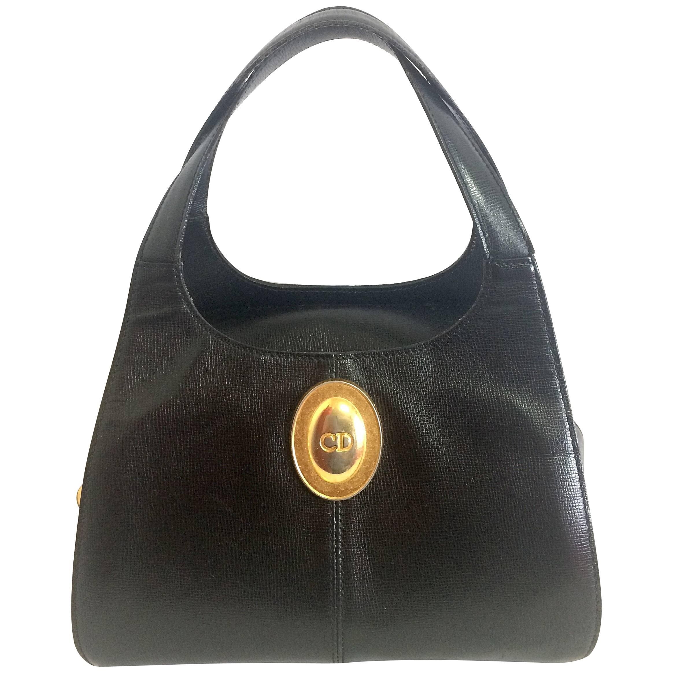 Vintage Christian Dior grained black leather handbag with oval golden CD logo.  For Sale