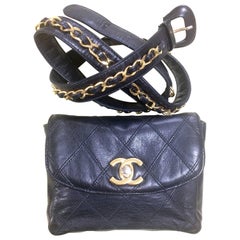 Vintage CHANEL black leather waist purse, fanny bag with golden chain belt.
