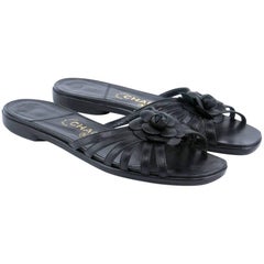 Chanel leather slides with Signature Camellia Adornment 