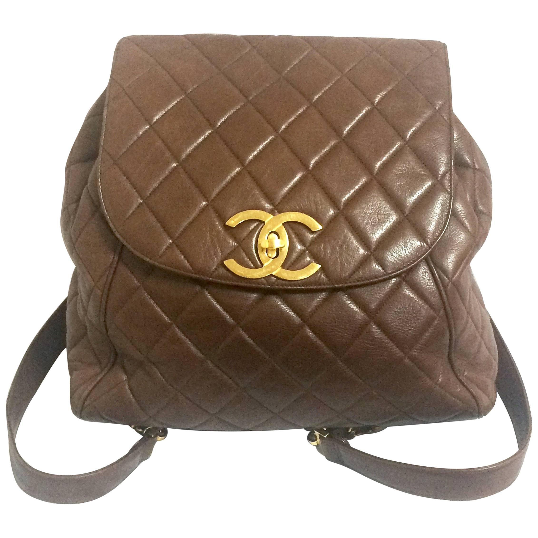 Vintage CHANEL quilted brown lamb leather backpack with gold chain and large CC. For Sale