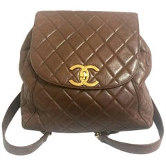 Vintage CHANEL quilted brown lamb leather backpack with gold chain and large CC.