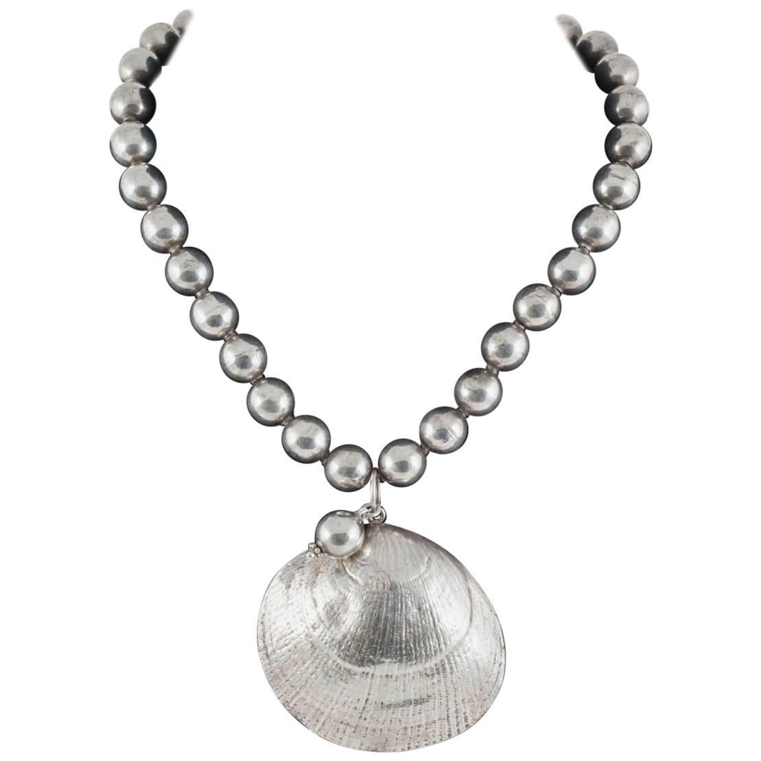 Sterling silver hand wrought 'clam shell' and hollow ball necklace, Mexican..