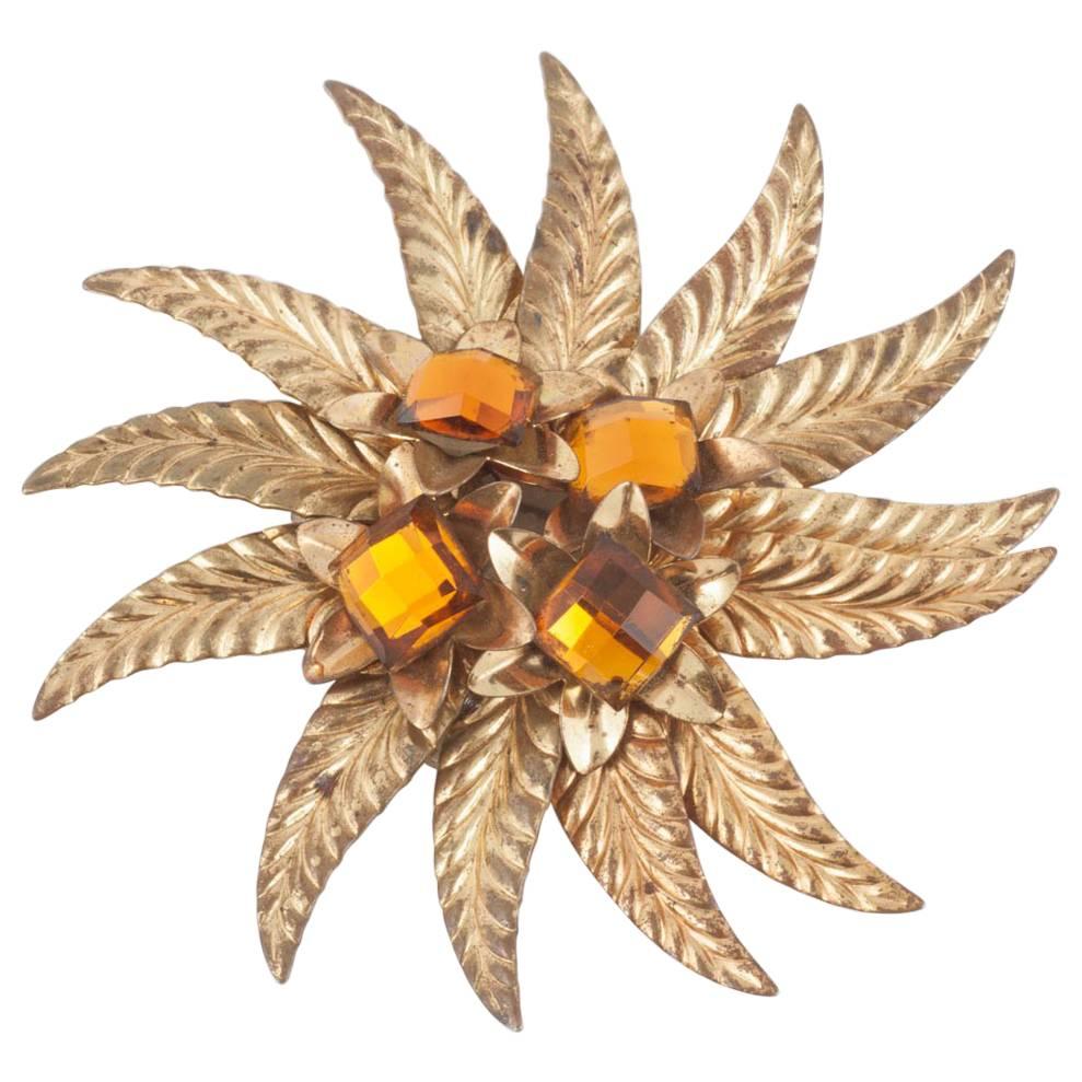 A striking gilt and topaz paste 'sunburst' brooch, Miriam Haskell, USA, 1930s. For Sale