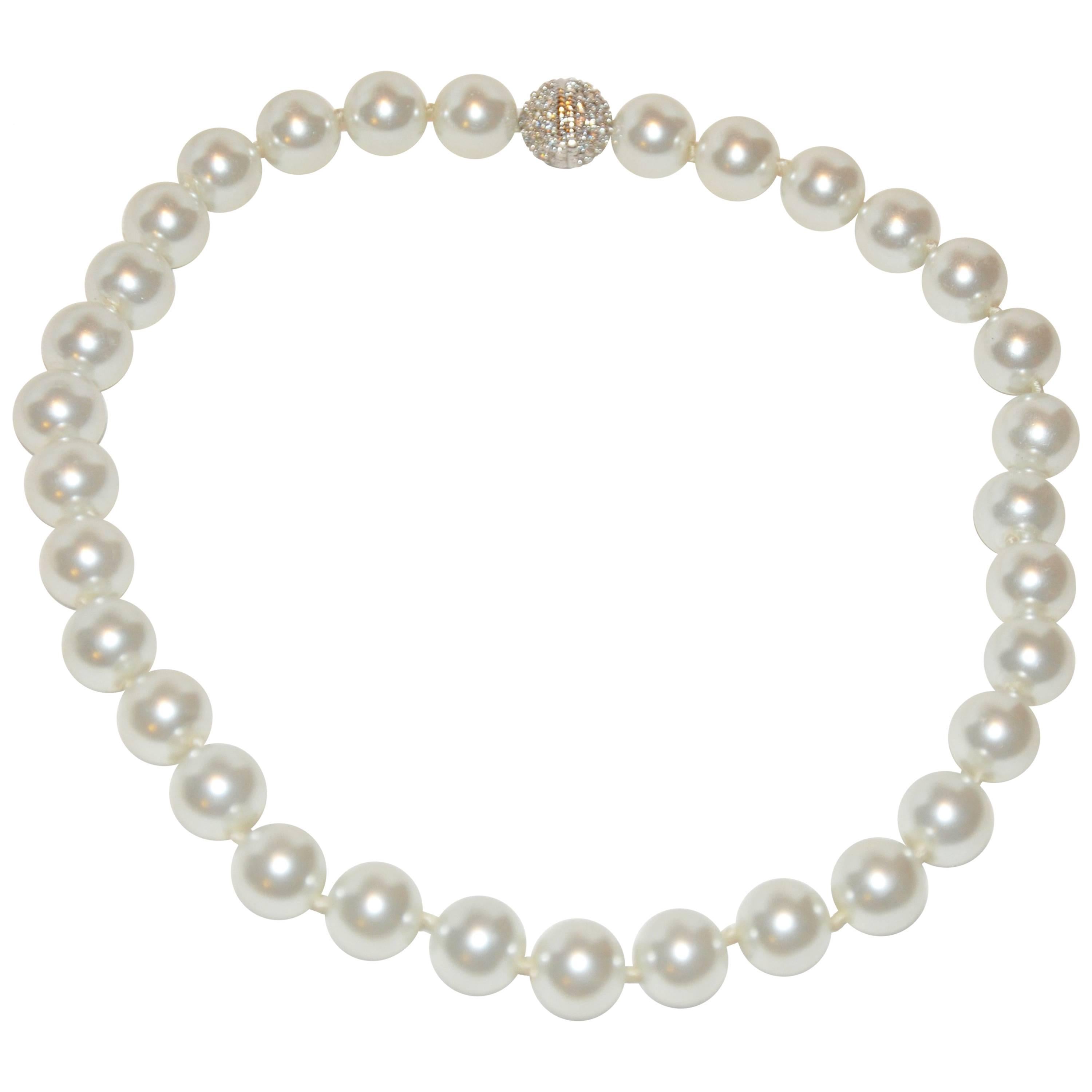 Grand collier d'inspiration Chanel en fausses perles accentué de strass en vente