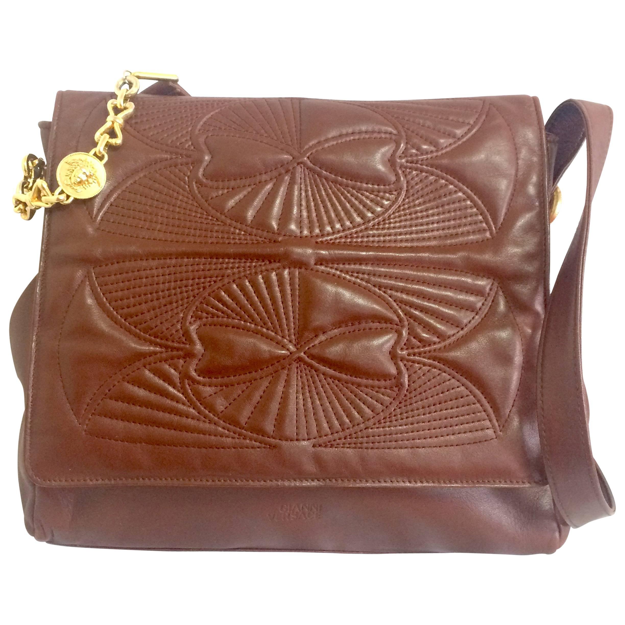 Vintage Gianni Versace brown messenger shoulder bag with golden medusa motifs. For Sale