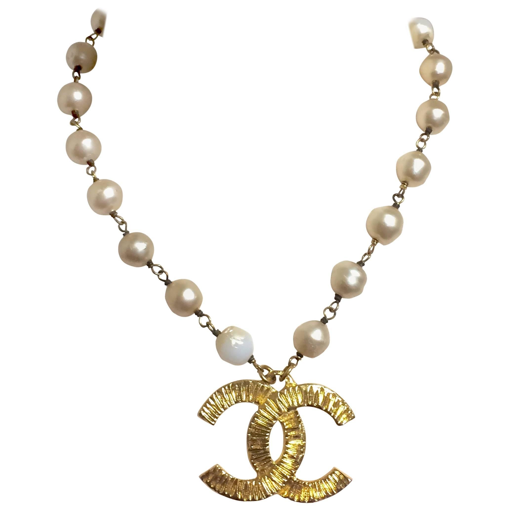 Vintage CHANEL white cream faux baroque pearl necklace with CC mark pendant top.