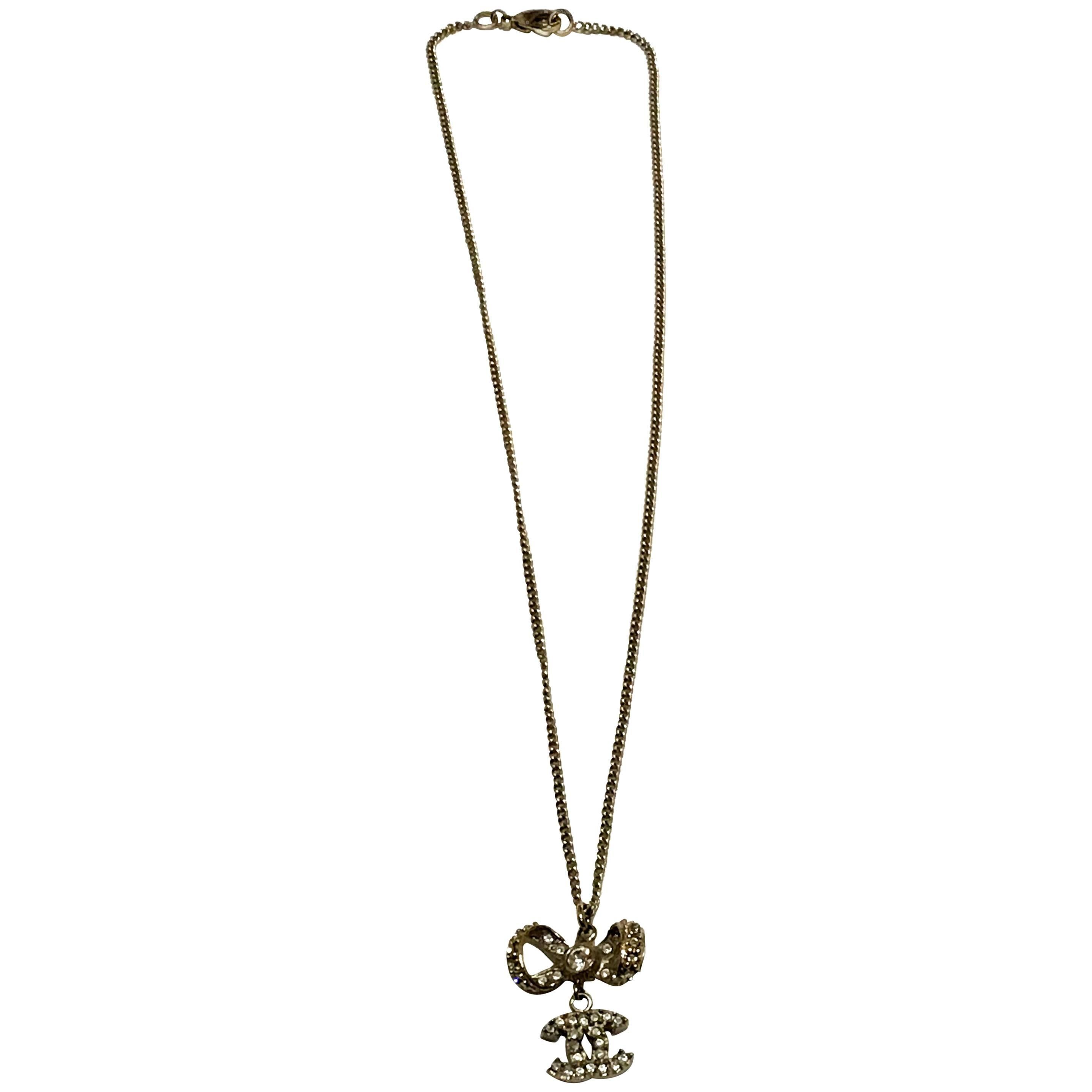Chanel Necklace - Gold Tone Metal - Bow with CC Logo Charm For Sale