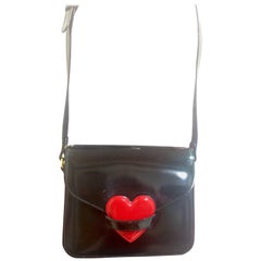 Vintage MOSCHINO black patent enamel leather shoulder bag with red heart motif.