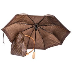 Sold at Auction: TWO VINTAGE LOUIS VUITTON UMBRELLAS. - Longer, app. 36 in.