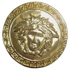 Vintage GIANNI VERSACE classic round pin brooch with its iconic medusa motif.