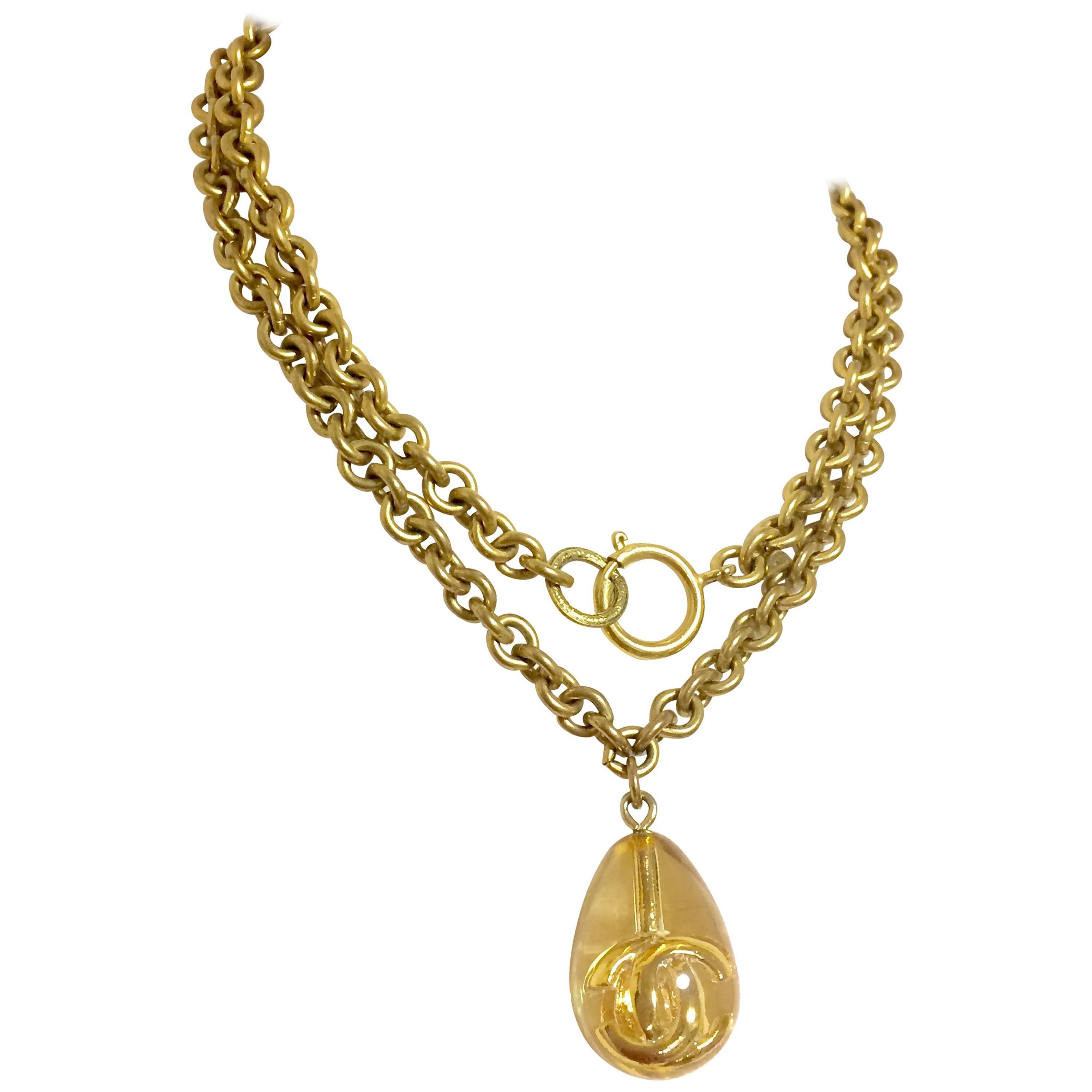 Vintage CHANEL long chain necklace with clear and gold teardrop CC pendant top. For Sale