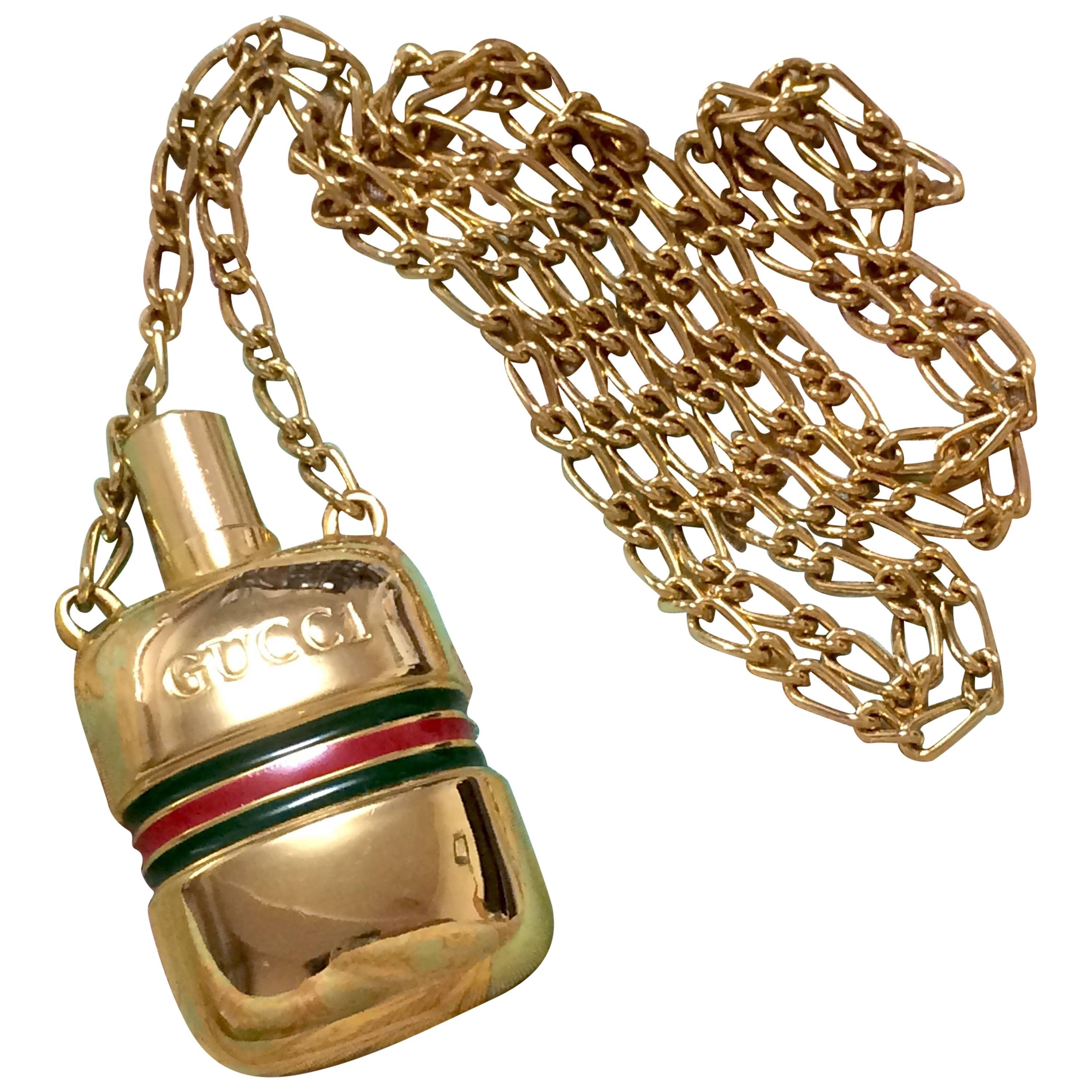 MINT. Vintage Gucci golden mini perfume bottle necklace with webbing line.