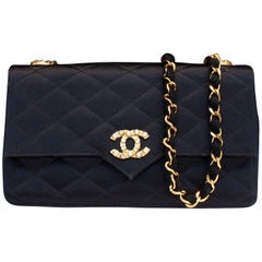 Chanel black satin clutch with golden hardware