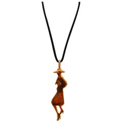 Yves Saint Laurent long silhouette pendant necklace composed of gilded metal and