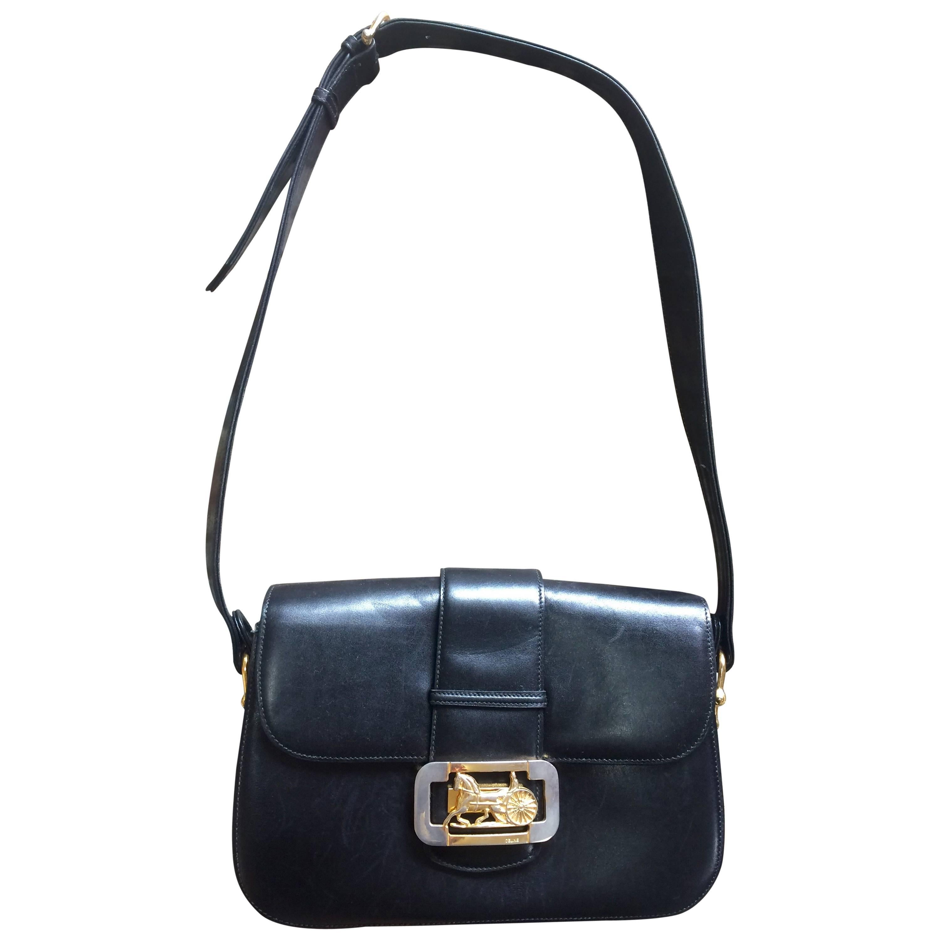 Vintage Celine black leather classic shoulder bag with golden logo closure.