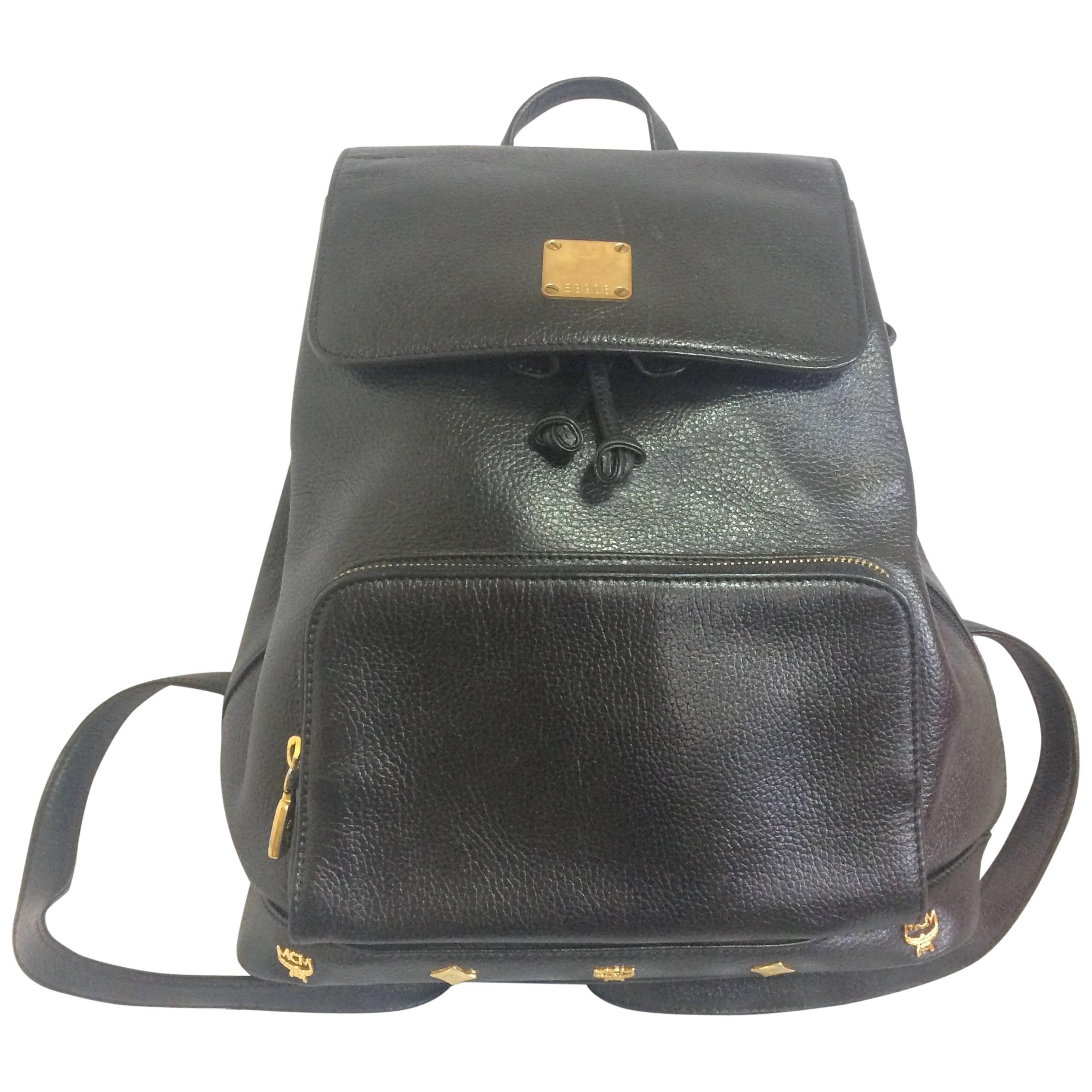 Vintage MCM black backpack with golden studded logos. Designed by Michael Cromer For Sale