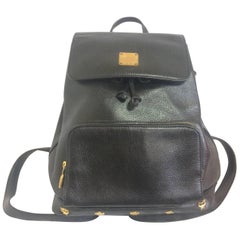 Vintage MCM black backpack with golden studded logos. Designed by Michael Cromer