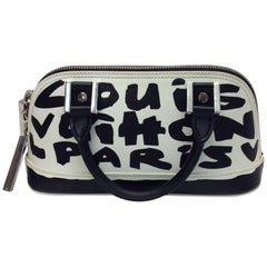 Lot - Alma Graffiti white and black glazed leather double handled handbag,  Louis Vuitton