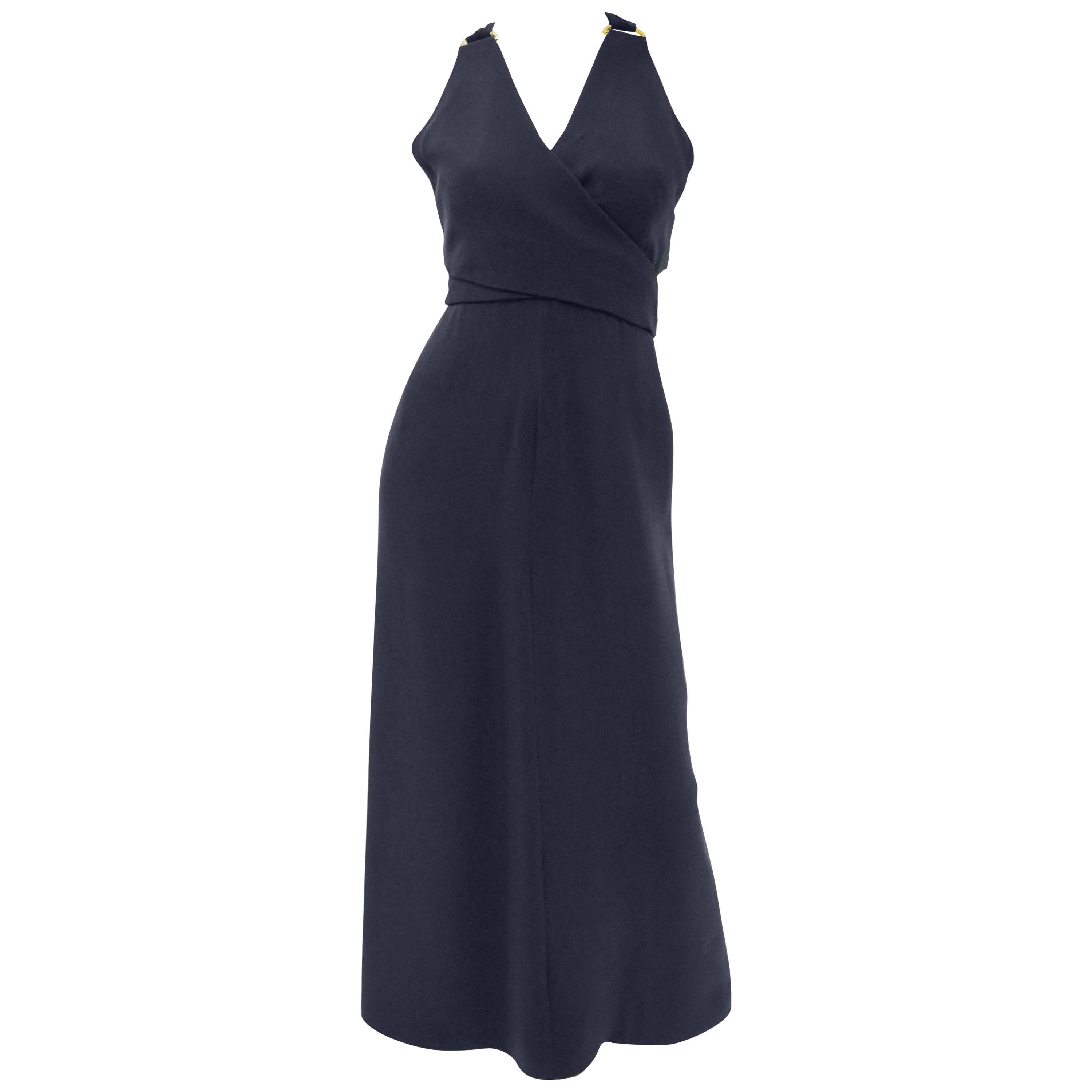 Oh Dior! 

Marc Bohan dreamt up this beautiful navy blue evening dress for Dior's 1971 Spring - Summer season. The dress features a v-neck surplice halter top above a floor-length sheath skirt. The dress has elongated straps that curve around the