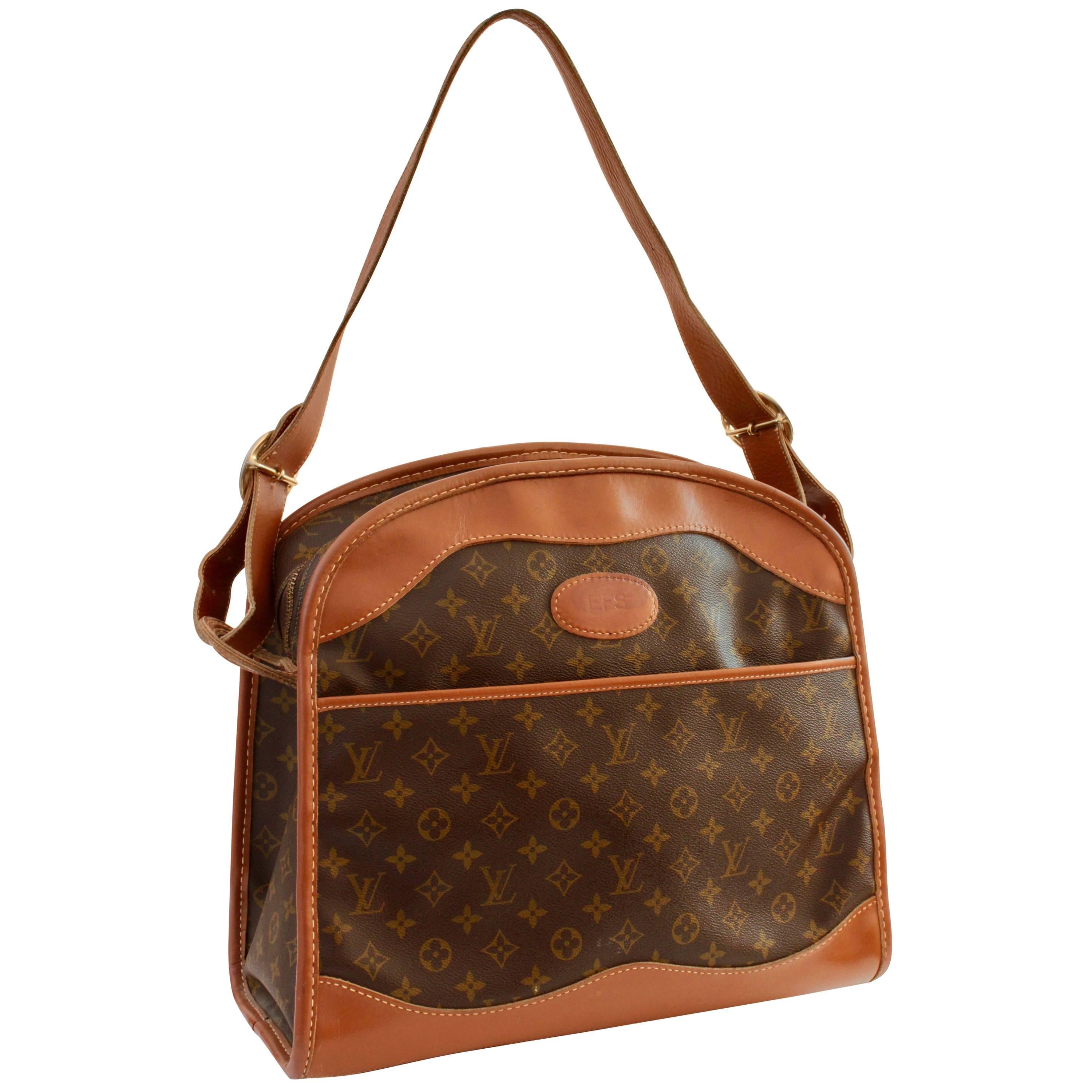 Travel in style with this sophisticated carry on bag, made by The French Company under special license by Louis Vuitton, most likely in the late 1970s.  Made from their signature monogram canvas, it features an adjustable shoulder strap, front zip