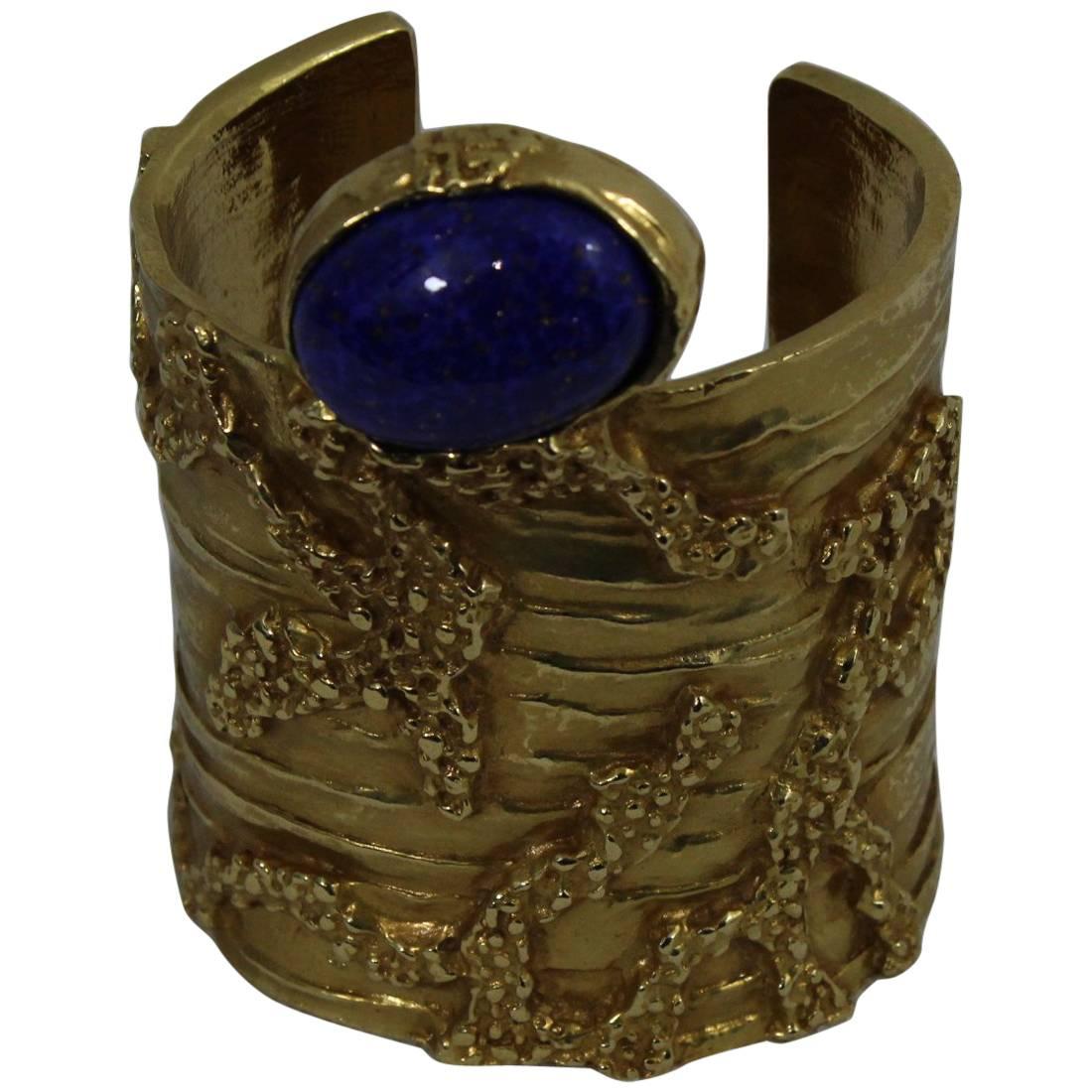 Yves saint Laurent Gold Artsy Bangle with Blue Stone For Sale
