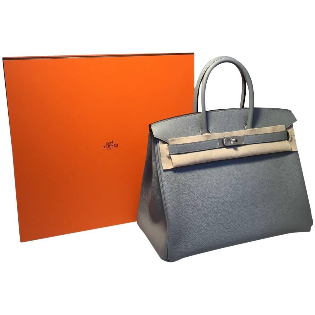 One of a kind custom Hermes Gris Mouette grey togo birkin 35cm in excellent- never used condition. Light Grey gris mouette togo leather exterior trimmed with rare brushed palladium silver hardware that still retains the plastic protective coating. 